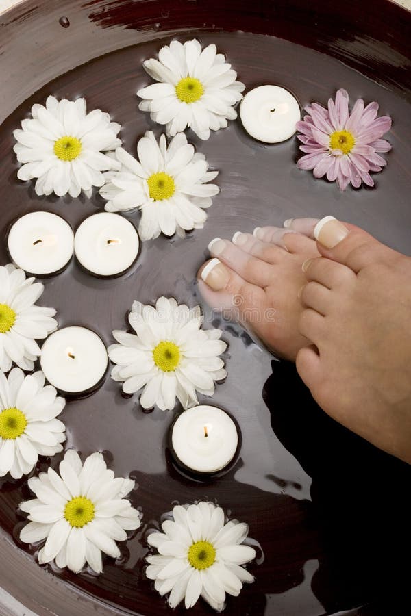 Woman's feet in bowl of water. Woman's feet in bowl of water