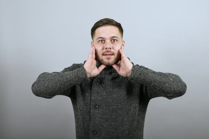 Verwirrter Mann hält Hände zu seinem Gesicht. schockierte erschrockene überraschte Menschen stockfoto