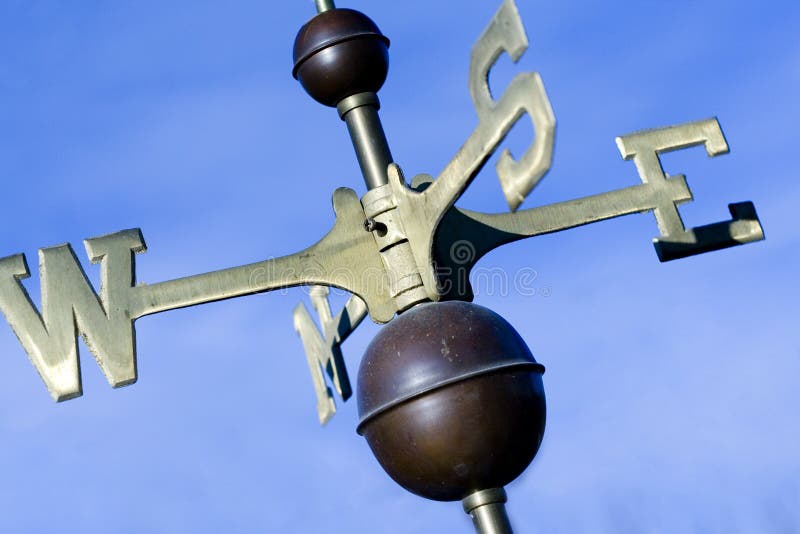 A weather vain with blue sky background. A weather vain with blue sky background