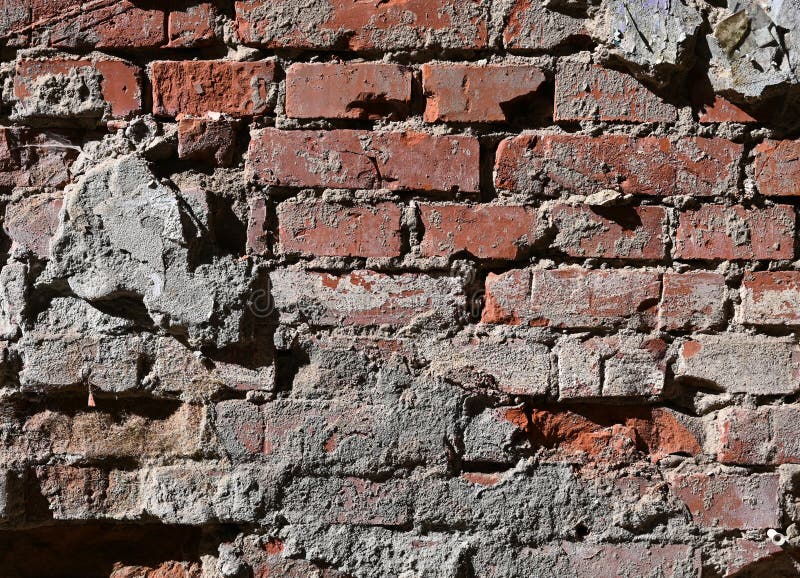 Verwitterte Ziegelmauer mit abgenutzten Texturen und freiliegendem Mörtel im urbanen Umfeld mit altersbedingten Zeichen lizenzfreies stockfoto