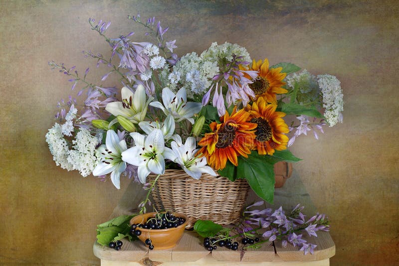 Very beautiful bouquet of garden flowers in a basket.Still life with flowers