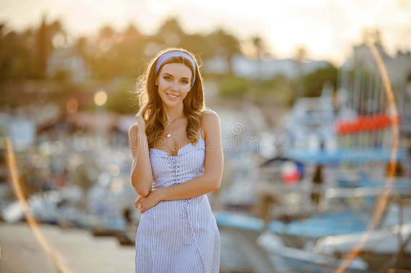 A very beautiful sensual and girl in a blue striped dress i