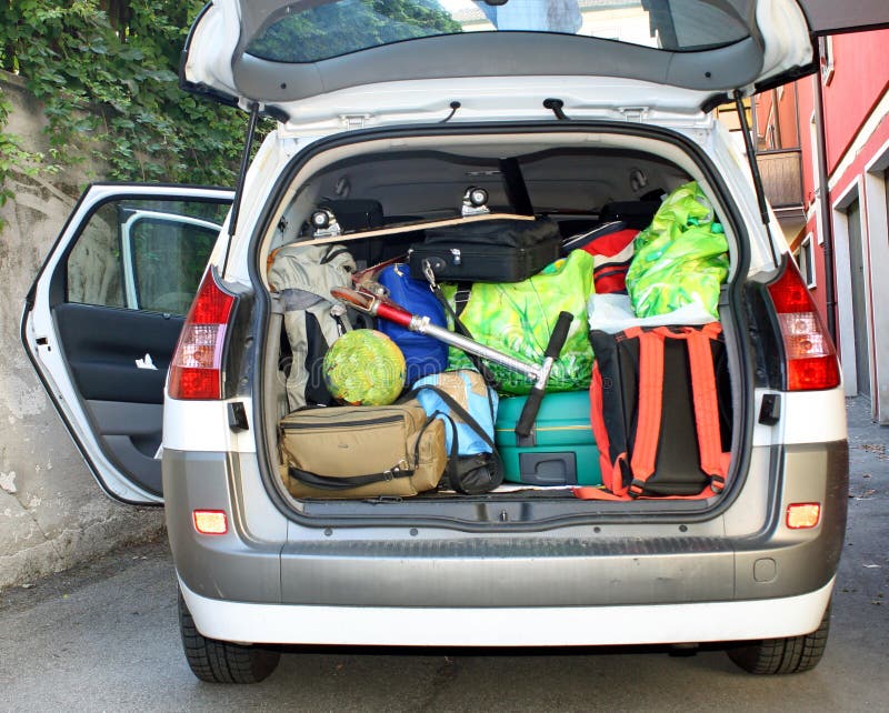 Very car with the trunk full of luggage ready for the departure of family holidays