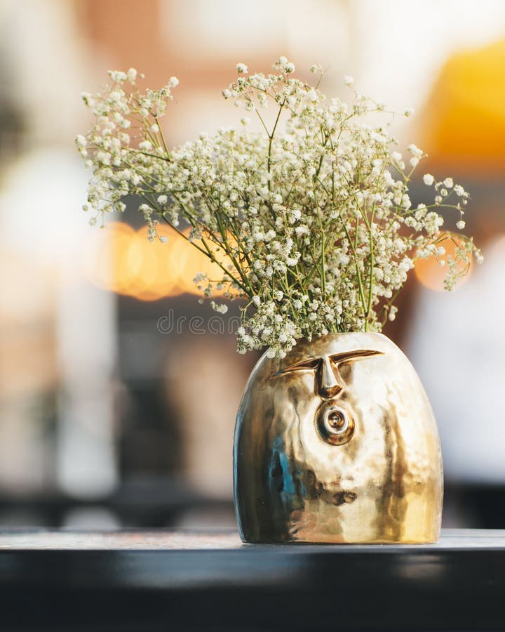 A Very Cool and Cheerful Vase with Spring Flowers is on a Table in a