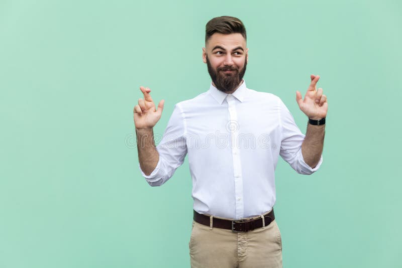 The very cunning businessman, crossing fingers for good luck, hoping wishes will come true, looking up slyly. royalty free stock photo The very cunning businessman, crossing fingers for good luck, hoping wishes will come true, looking up slyly. royalty free stock photo