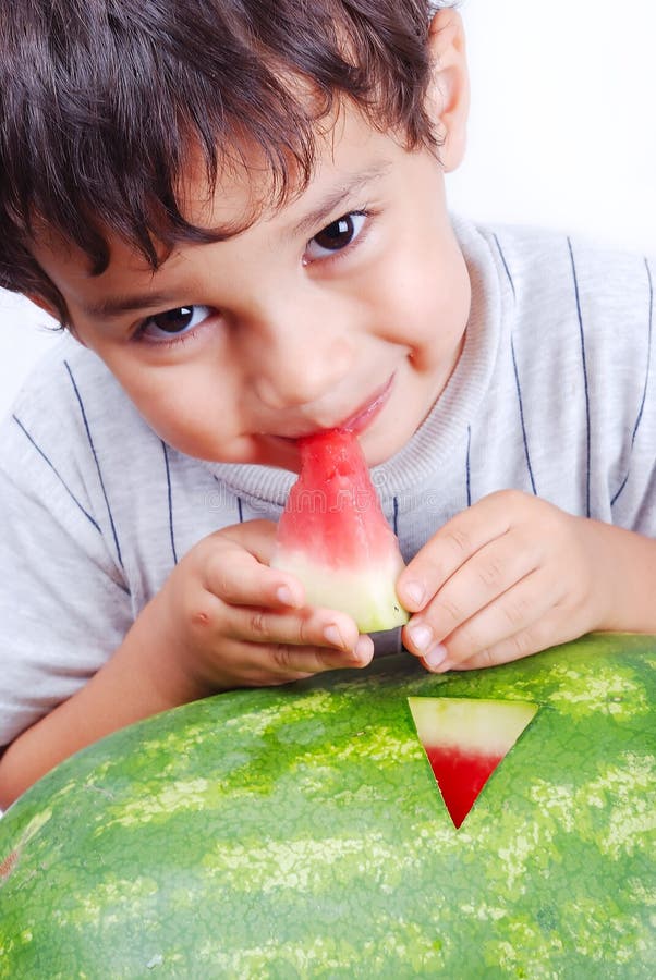 Very cute kid eating watermelon