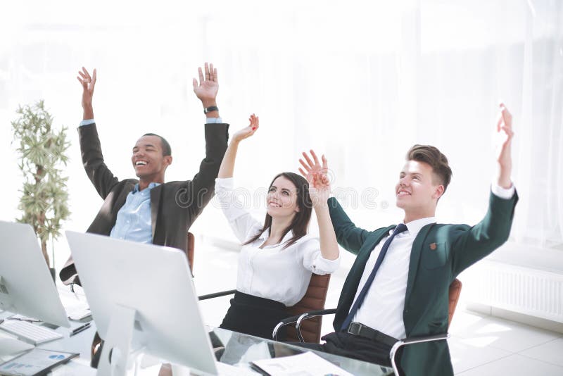 Very happy business team sitting at Desk stock photo Very happy business team sitting at Desk stock photo
