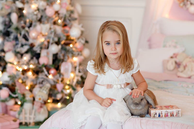 Very nice charming little girl blonde in white dress laughs and stock photography Very nice charming little girl blonde in white dress laughs and stock photography