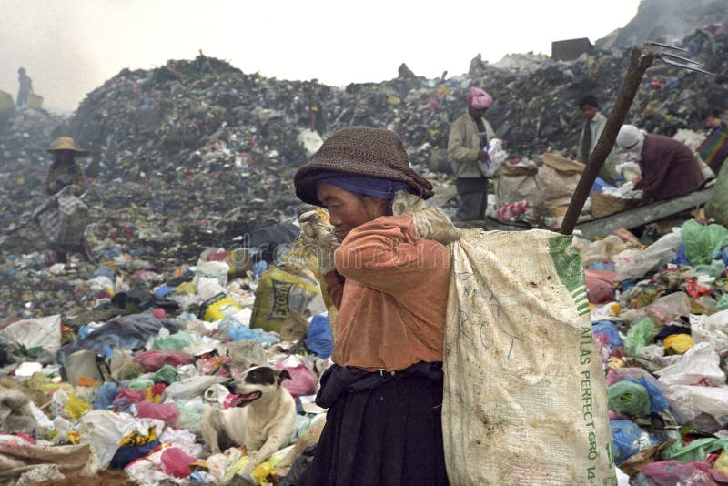 Very old Filipino woman working on landfill, dump