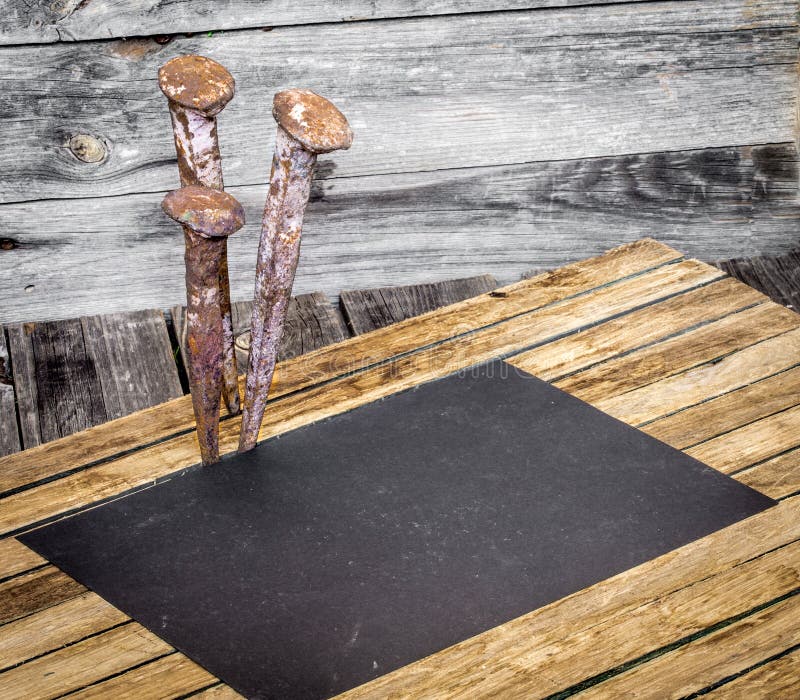 very old large nails on a beautiful wooden background, rusty