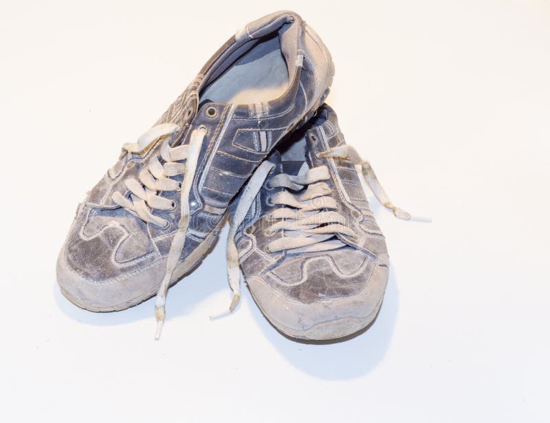 Very Old Running Shoes with Laces on a Light Background. Stock Photo Image of hole, clothes