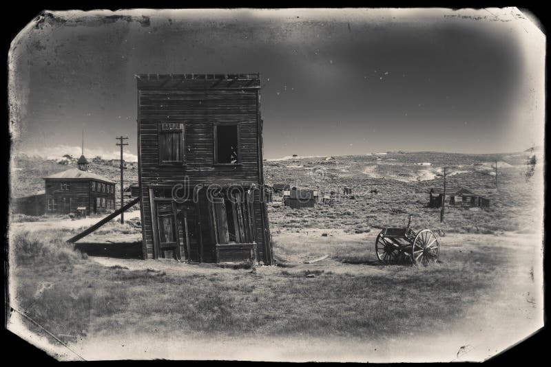 Very old sepia vintage photo with abandoned western building in the middle of a desert