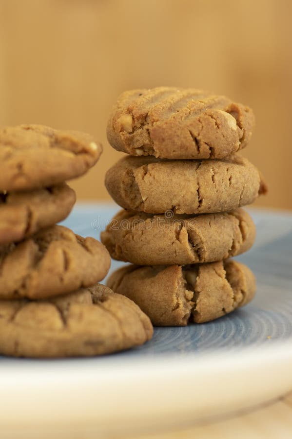 Very tasty peanut butter biscuits on bamboo light brown wooden board, golden baked healthy