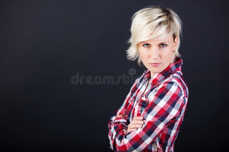 Portrait of a angry young woman against black background. Portrait of a angry young woman against black background