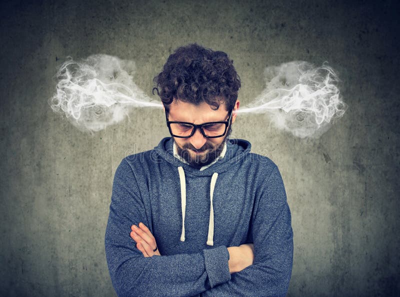 Angry young man, blowing steam coming out of ears, about to have nervous breakdown isolated on gray background. Negative human emotions face expression feelings. Angry young man, blowing steam coming out of ears, about to have nervous breakdown isolated on gray background. Negative human emotions face expression feelings