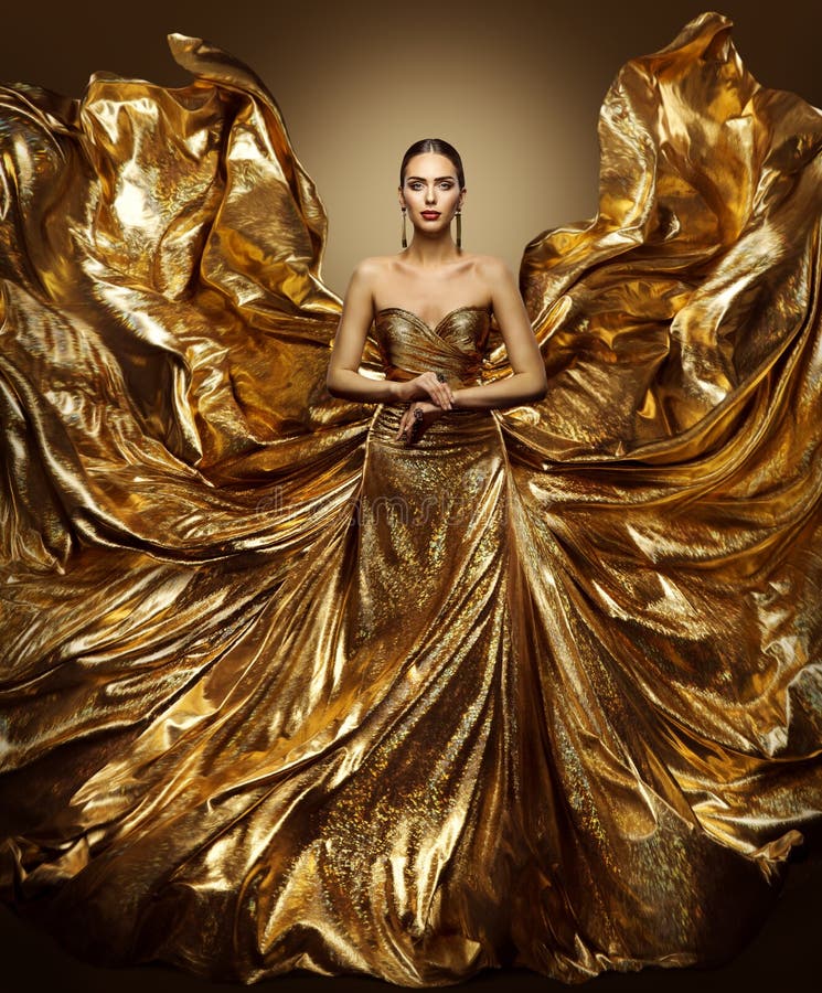 Vestito da volo della donna dell'oro, modello di moda in abito dorato d'ondeggiamento di arte fotografie stock libere da diritti Vestito da volo della donna dell'oro, modello di moda in abito dorato d'ondeggiamento di arte fotografie stock libere da diritti