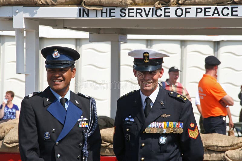 UN mission veterans on Veterans Day. One black, one white. Text: In the Service of Peace. June 26, 2010, the Hague, Holland. UN mission veterans on Veterans Day. One black, one white. Text: In the Service of Peace. June 26, 2010, the Hague, Holland.