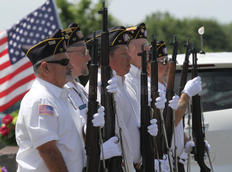 21 gun salute. Soldiers or veterans with guns and American flag prepare to shoot. Post 27 Honor Guard. Sallisaw City Cemetery, Sallisaw, Oklahoma, Memorial Day, May 29, 2017 during Memorial Day services or program. 21 gun salute. Soldiers or veterans with guns and American flag prepare to shoot. Post 27 Honor Guard. Sallisaw City Cemetery, Sallisaw, Oklahoma, Memorial Day, May 29, 2017 during Memorial Day services or program.