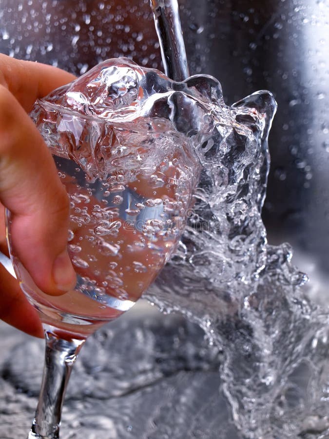 Moment during the filling of water in a glass. Moment during the filling of water in a glass...