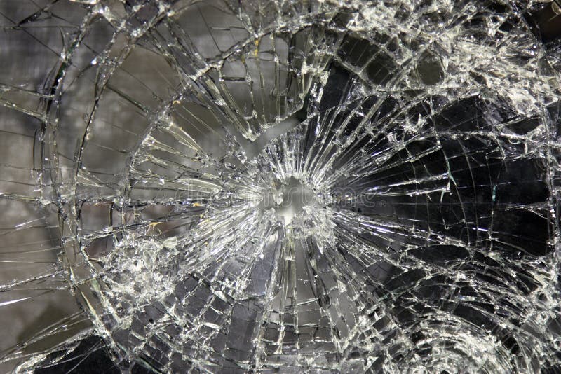 A large glass pane broken in pieces. A pane of glass or flat sheet of glass in a window or door. A large glass pane broken in pieces. A pane of glass or flat sheet of glass in a window or door