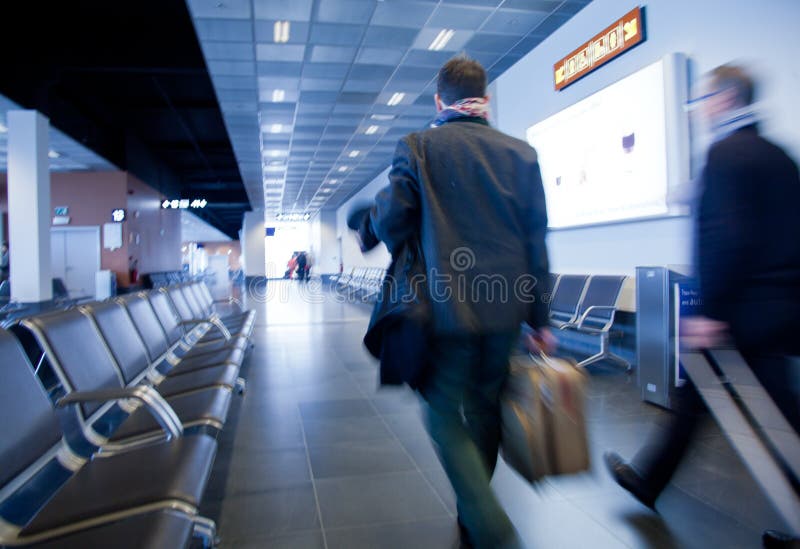 Business travel people carrying luggage to departure gate preparing to travel by plane. Business travel people carrying luggage to departure gate preparing to travel by plane