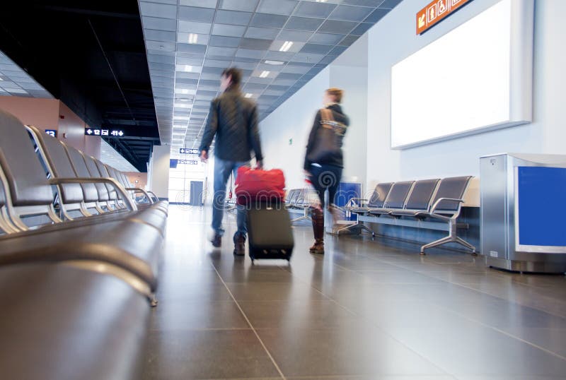 Travelers in airport scene, people carrying luggage to departure gate preparing to travel by plane. Travelers in airport scene, people carrying luggage to departure gate preparing to travel by plane