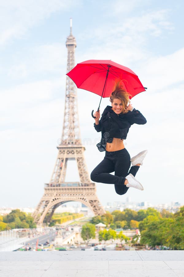 Viaje feliz de la muchacha en París, Francia La mujer salta con el paraguas de la moda Parisiense en el fondo blanco Mujer con fotos de archivo Viaje feliz de la muchacha en París, Francia La mujer salta con el paraguas de la moda Parisiense en el fondo blanco Mujer con fotos de archivo
