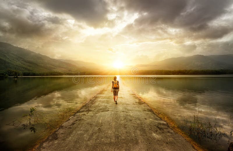 Traveler walking along the road to the mountains. Traveler walking along the road to the mountains.