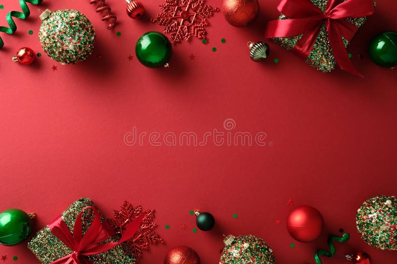 Vibrant Christmas flat lay with gift boxes and baubles on red backdrop royalty free stock photography