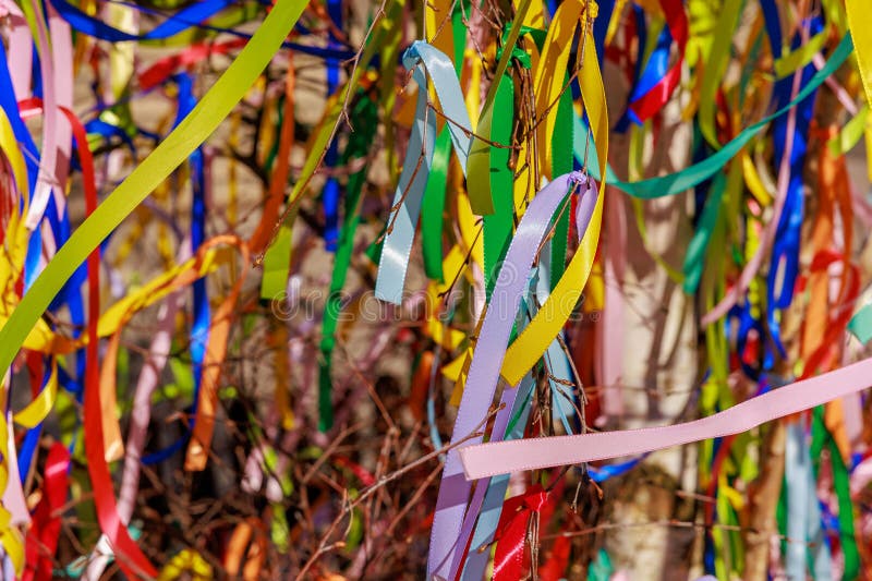 Vibrant colorful ribbons on branches create festive outdoor scene stock photos