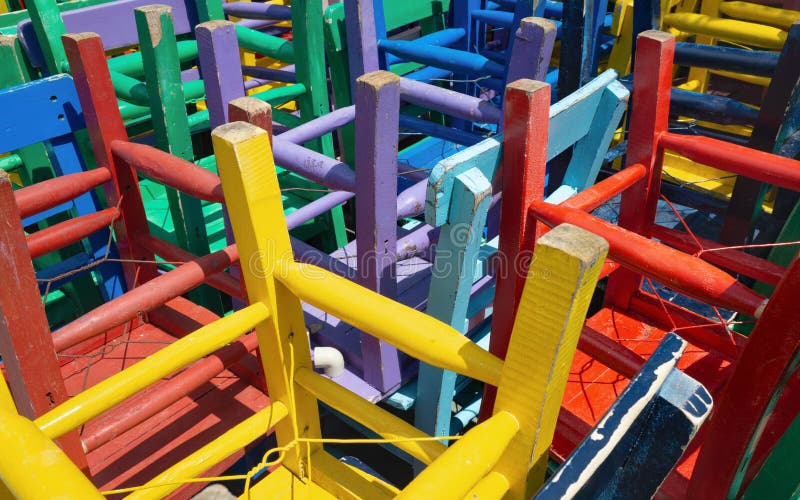 Vibrant colorful wooden chair legs, stacked upside down royalty free stock photos
