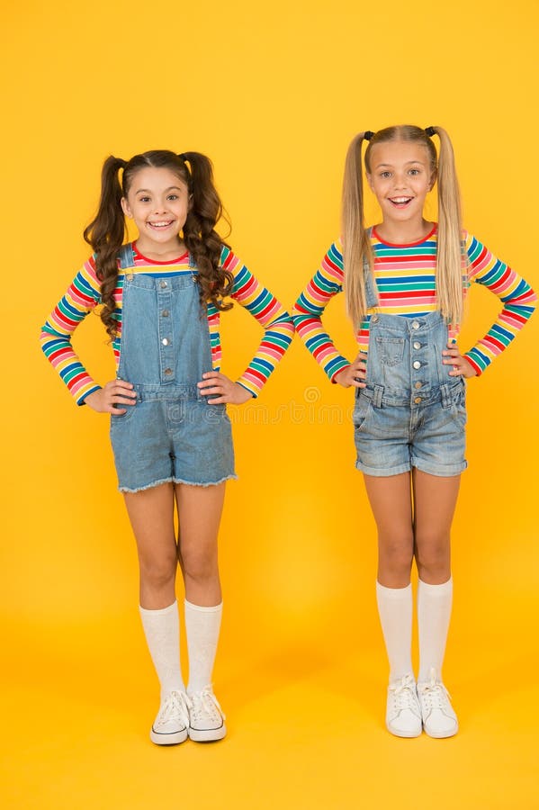 Vibrant colors. Modern fashion. Kids fashion. Girls long hair. Cute children same outfits. Little girls wearing rainbow