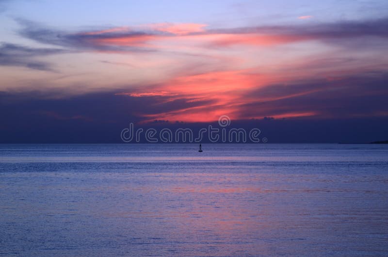 Vibrant Orange Color Sunset Afterglow Over the Blue Sea Stock Photo