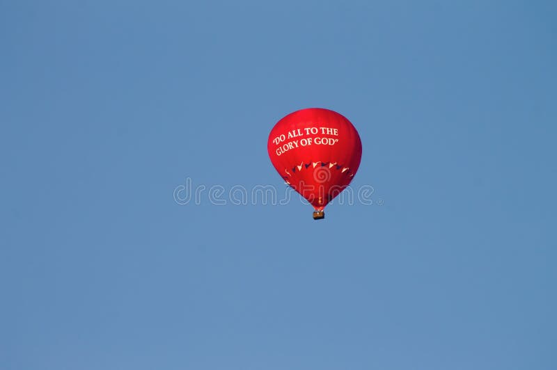 Vibrant red balloon floating in the sky, with the words &x27;do all to the glory god&x27; printed on it