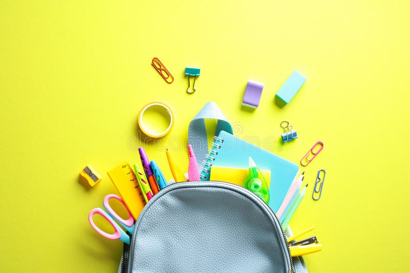 Vibrant School Supplies Spill from Backpack royalty free stock photos