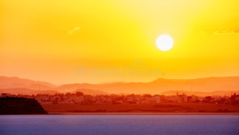 Vibrant and soften view of nice sunset over dry salt lake in Cyprus Larnaca in summer