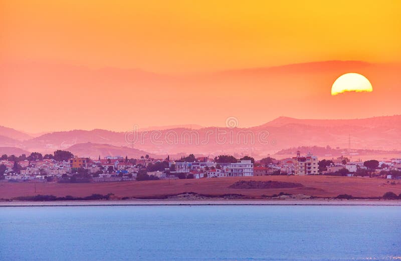 Vibrant and soften view of nice sunset over dry salt lake in Cyprus Larnaca in summer