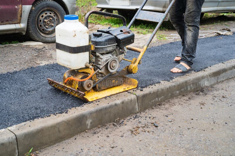 Vibroplite, a construction tool that performs trambing work of pavement stock photography