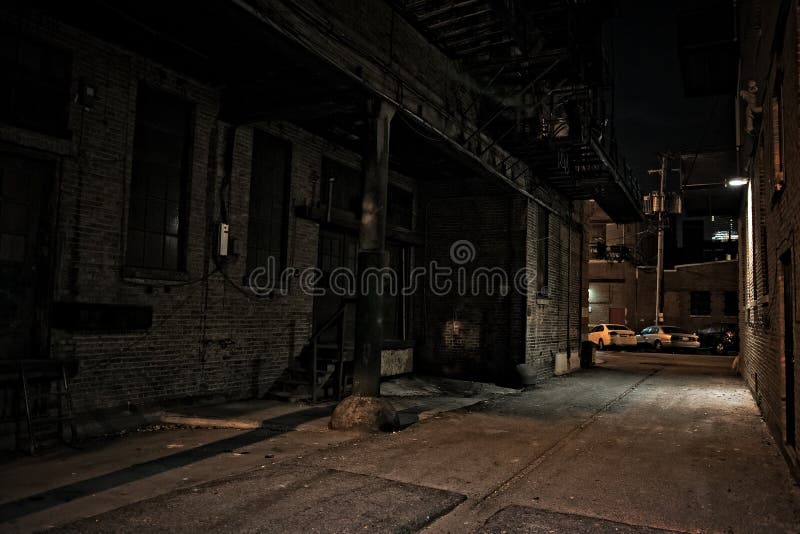 Dark urban city alley at night with loading dock and cars. Dark urban city alley at night with loading dock and cars.