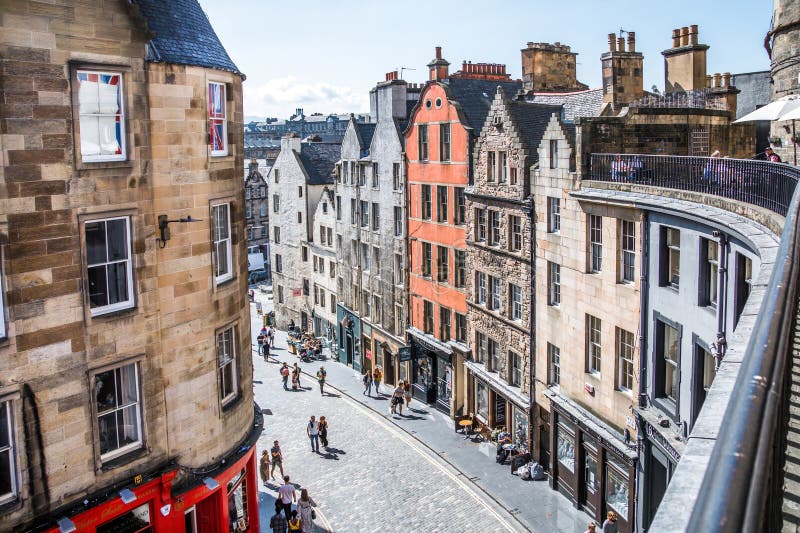 Scotland, Edinburg - August 24, 2022: Victoria street with beautiful curve and colourful shopfronts, built in 1860th and designed in the fashionable Scots Baronial style. Scotland, Edinburg - August 24, 2022: Victoria street with beautiful curve and colourful shopfronts, built in 1860th and designed in the fashionable Scots Baronial style.