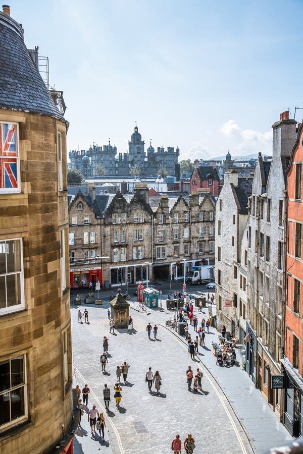 Scotland, Edinburg - August 24, 2022: Victoria street with beautiful curve and colourful shopfronts, built in 1860th and designed in the fashionable Scots Baronial style. Scotland, Edinburg - August 24, 2022: Victoria street with beautiful curve and colourful shopfronts, built in 1860th and designed in the fashionable Scots Baronial style.