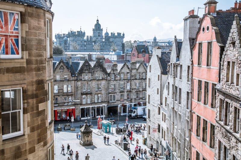 Scotland, Edinburg - August 24, 2022: Victoria street with beautiful curve and colourful shopfronts, built in 1860th and designed in the fashionable Scots Baronial style. Scotland, Edinburg - August 24, 2022: Victoria street with beautiful curve and colourful shopfronts, built in 1860th and designed in the fashionable Scots Baronial style.