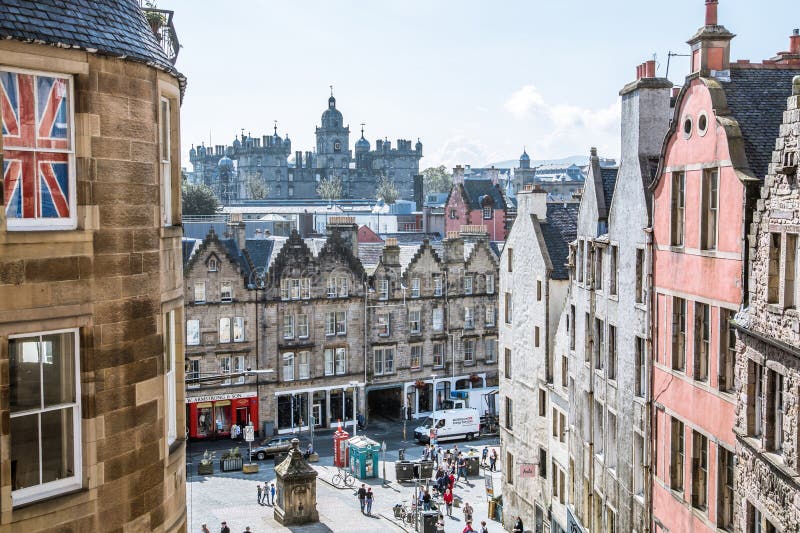 Scotland, Edinburg - August 24, 2022: Victoria street with beautiful curve and colourful shopfronts, built in 1860th and designed in the fashionable Scots Baronial style. Scotland, Edinburg - August 24, 2022: Victoria street with beautiful curve and colourful shopfronts, built in 1860th and designed in the fashionable Scots Baronial style.