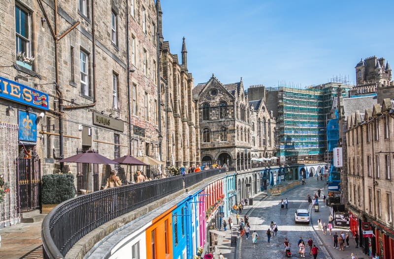 Scotland, Edinburg - August 24, 2022: Victoria street with beautiful curve and colourful shopfronts, built in 1860th and designed in the fashionable Scots Baronial style. Scotland, Edinburg - August 24, 2022: Victoria street with beautiful curve and colourful shopfronts, built in 1860th and designed in the fashionable Scots Baronial style.