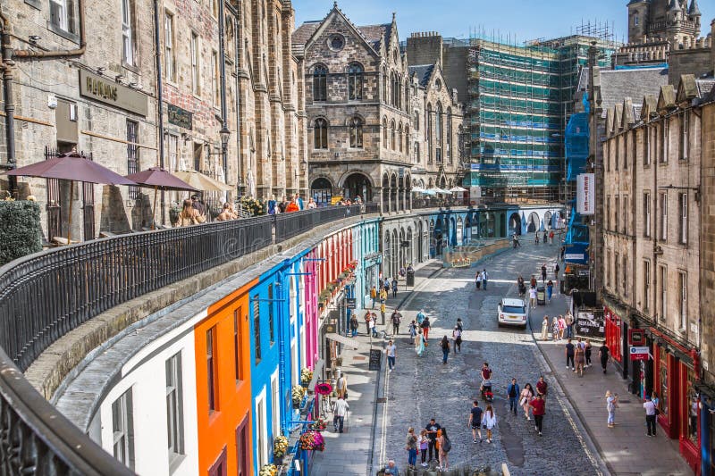 Scotland, Edinburg - August 24, 2022: Victoria street with beautiful curve and colourful shopfronts, built in 1860th and designed in the fashionable Scots Baronial style. Scotland, Edinburg - August 24, 2022: Victoria street with beautiful curve and colourful shopfronts, built in 1860th and designed in the fashionable Scots Baronial style.