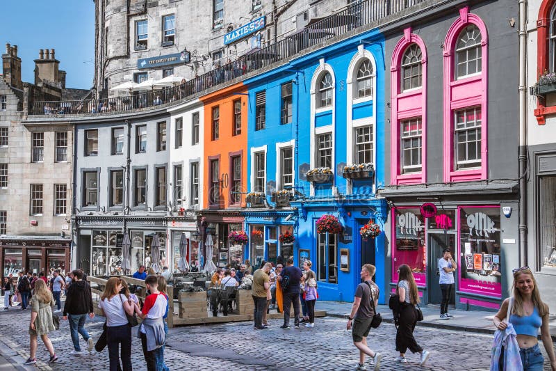 Scotland, Edinburg - August 24, 2022: Victoria street with beautiful curve and colourful shopfronts, built in 1860th and designed in the fashionable Scots Baronial style. Scotland, Edinburg - August 24, 2022: Victoria street with beautiful curve and colourful shopfronts, built in 1860th and designed in the fashionable Scots Baronial style.