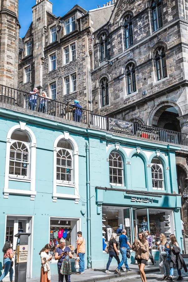 Scotland, Edinburg - August 24, 2022: Victoria street with beautiful curve and colourful shopfronts, built in 1860th and designed in the fashionable Scots Baronial style. Scotland, Edinburg - August 24, 2022: Victoria street with beautiful curve and colourful shopfronts, built in 1860th and designed in the fashionable Scots Baronial style.