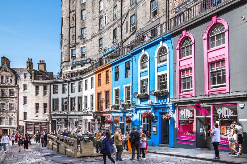 Scotland, Edinburg - August 24, 2022: Victoria street with beautiful curve and colourful shopfronts, built in 1860th and designed in the fashionable Scots Baronial style. Scotland, Edinburg - August 24, 2022: Victoria street with beautiful curve and colourful shopfronts, built in 1860th and designed in the fashionable Scots Baronial style.