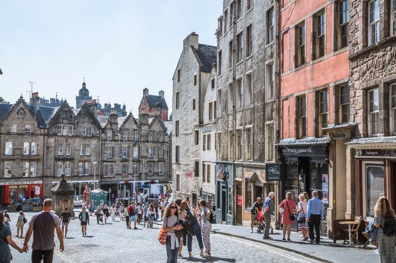 Scotland, Edinburg - August 24, 2022: Victoria street with beautiful curve and colourful shopfronts, built in 1860th and designed in the fashionable Scots Baronial style. Scotland, Edinburg - August 24, 2022: Victoria street with beautiful curve and colourful shopfronts, built in 1860th and designed in the fashionable Scots Baronial style.