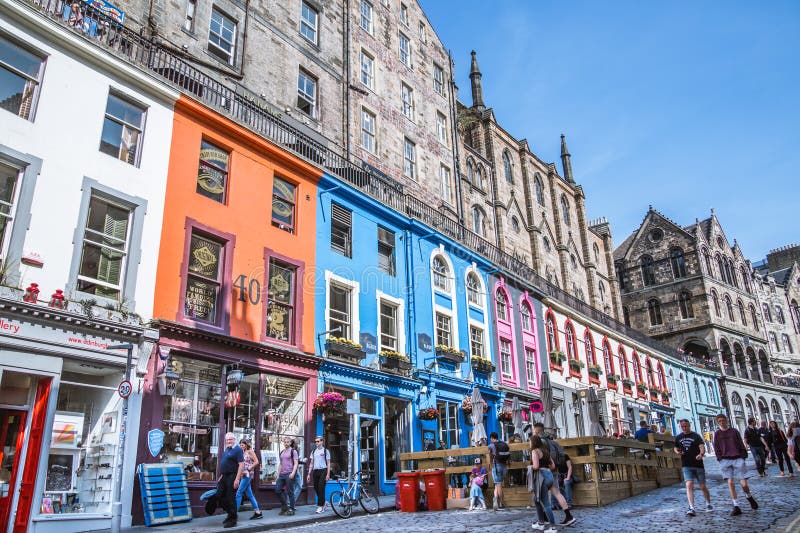 Scotland, Edinburg - August 24, 2022: Victoria street with beautiful curve and colourful shopfronts, built in 1860th and designed in the fashionable Scots Baronial style. Scotland, Edinburg - August 24, 2022: Victoria street with beautiful curve and colourful shopfronts, built in 1860th and designed in the fashionable Scots Baronial style.